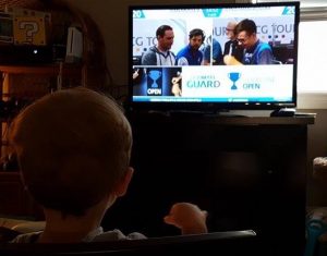 Theo watching his dad as he is on event coverage
